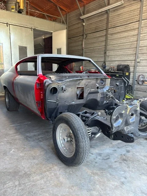 Custom paint technician polishing a vehicle